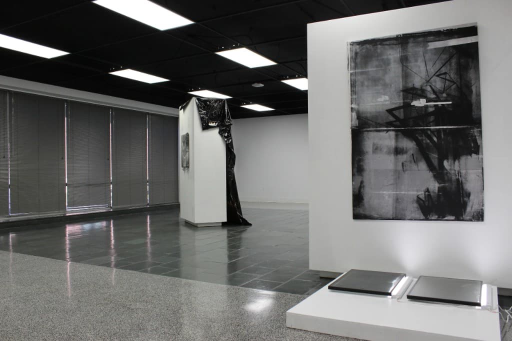 Gallery installation view: large-scale painting, sculptural forms, and mixed media in an exhibition space